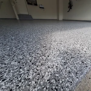 Close-up of garage floor with Outer Space flake color from Galaxy Concrete.